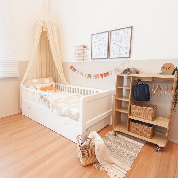 Solid-wood house-frame junior bed styled in a warm Montessori nursery