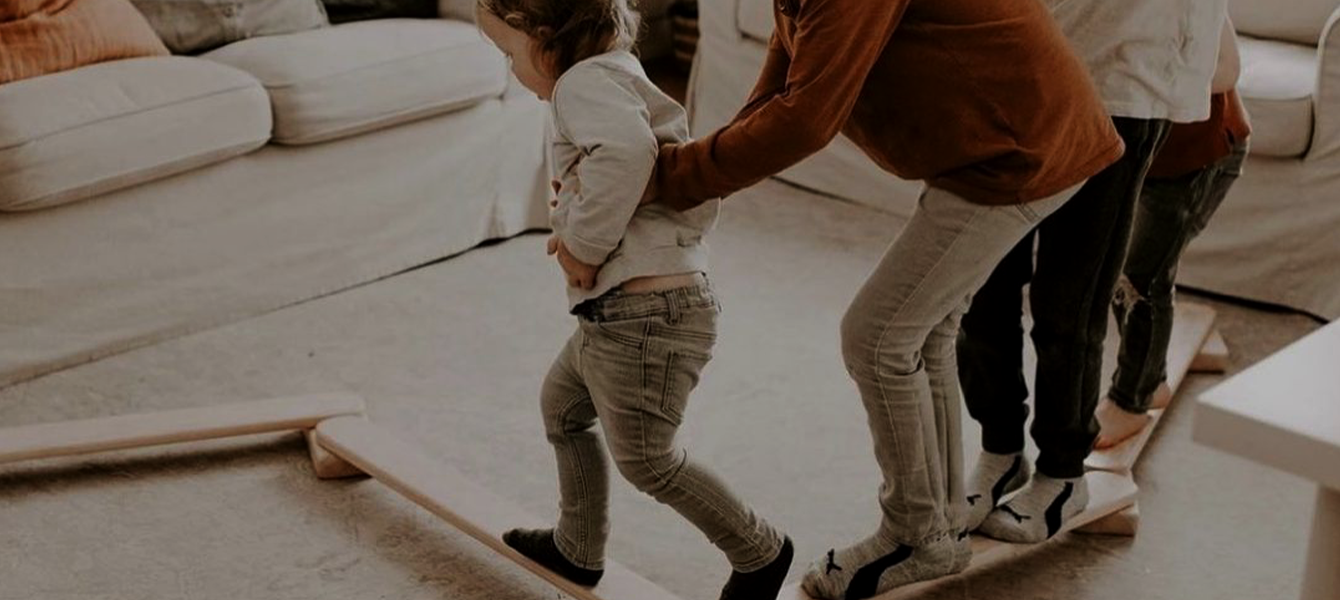 Child climbing a custom solid-wood Cuddle Gently bed